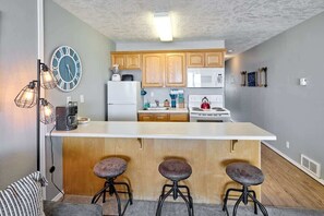 Enjoy cooking in this fully equipped kitchen with a stove, refrigerator, and microwave.