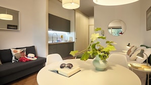 A modern living space with a dining area, a kitchen, and a seating area. - Colourful apartment  St. Peter's View (ROMA)