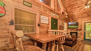 A rustic wooden interior with a bar area, a fireplace, and a television. - 🐾A Mountain Heart Song🔥Pet-Friendly, Fire Pit, Hot Tub & Gazebo (Sevierville)
