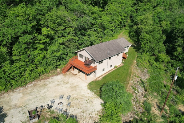 A single-story house with a red deck and a small patio area. - Harpers Haven (Lansing)