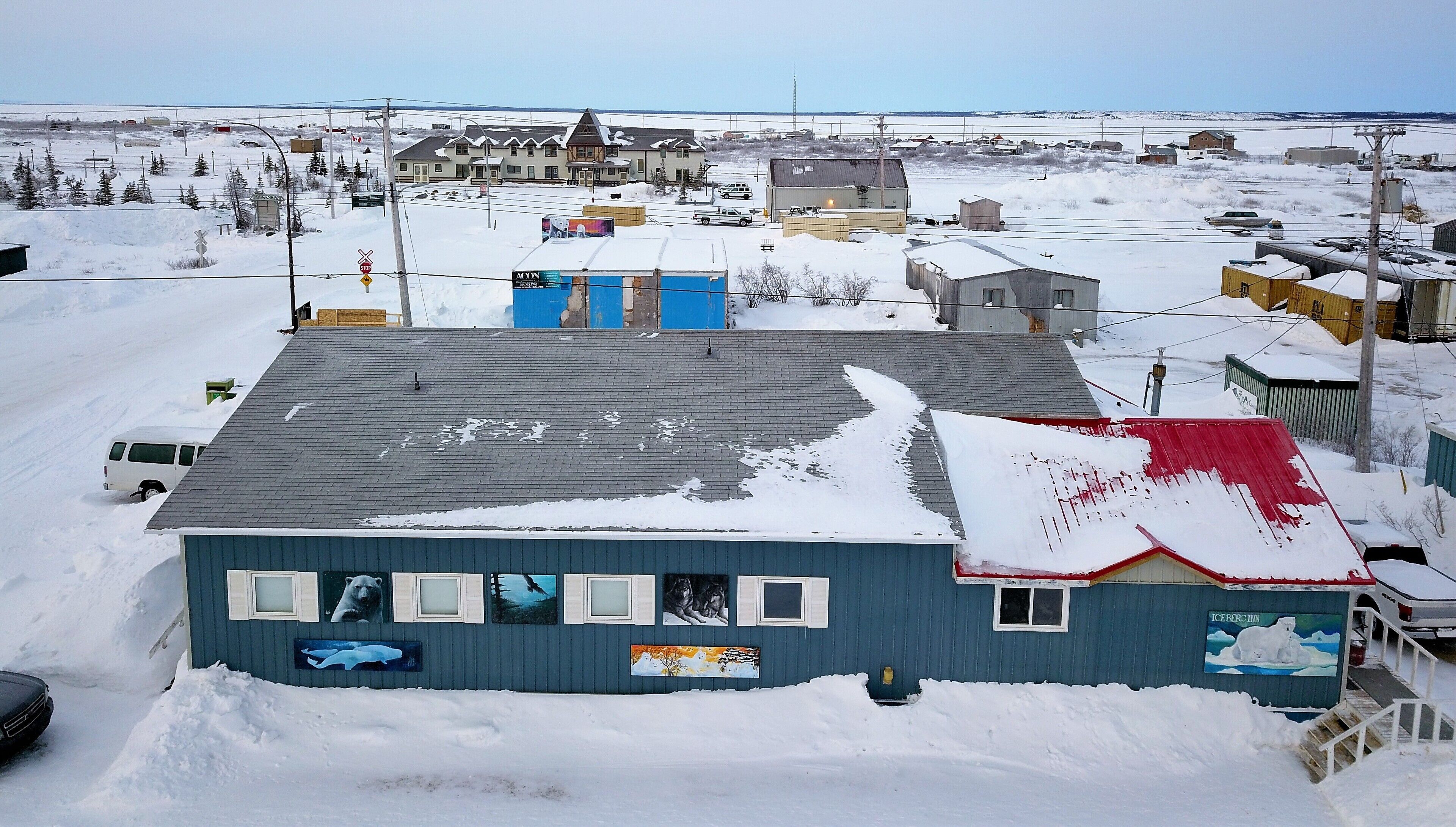 A building with a snow-covered roof and a mural of polar bears.