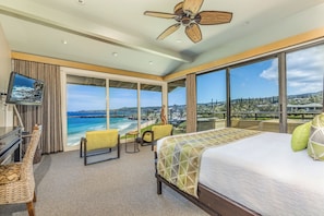 Relax in this serene room with a large bed, ocean views, and a balcony.