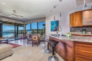 Relax in a spacious living area with a comfortable sofa and dining table, and enjoy a scenic view from the large window.