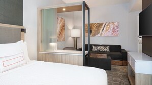 A modern hotel room with a bed, a desk, a sofa, and a TV. - SpringHill Suites by Marriott Tifton (Tifton)