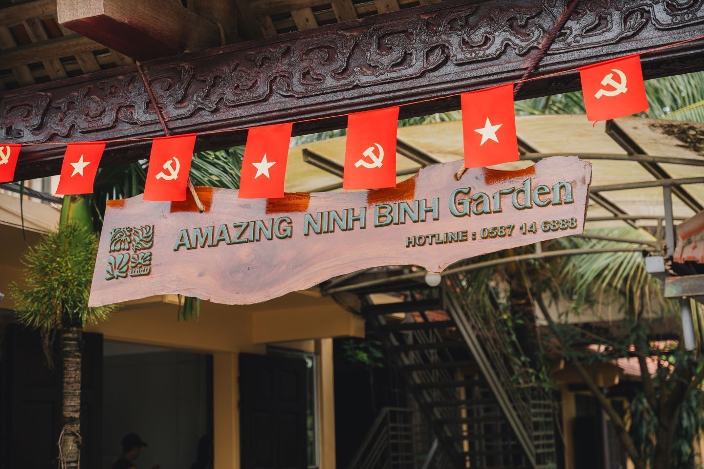 A sign for 'AMAZING NINH BINH Garden' with a contact number.