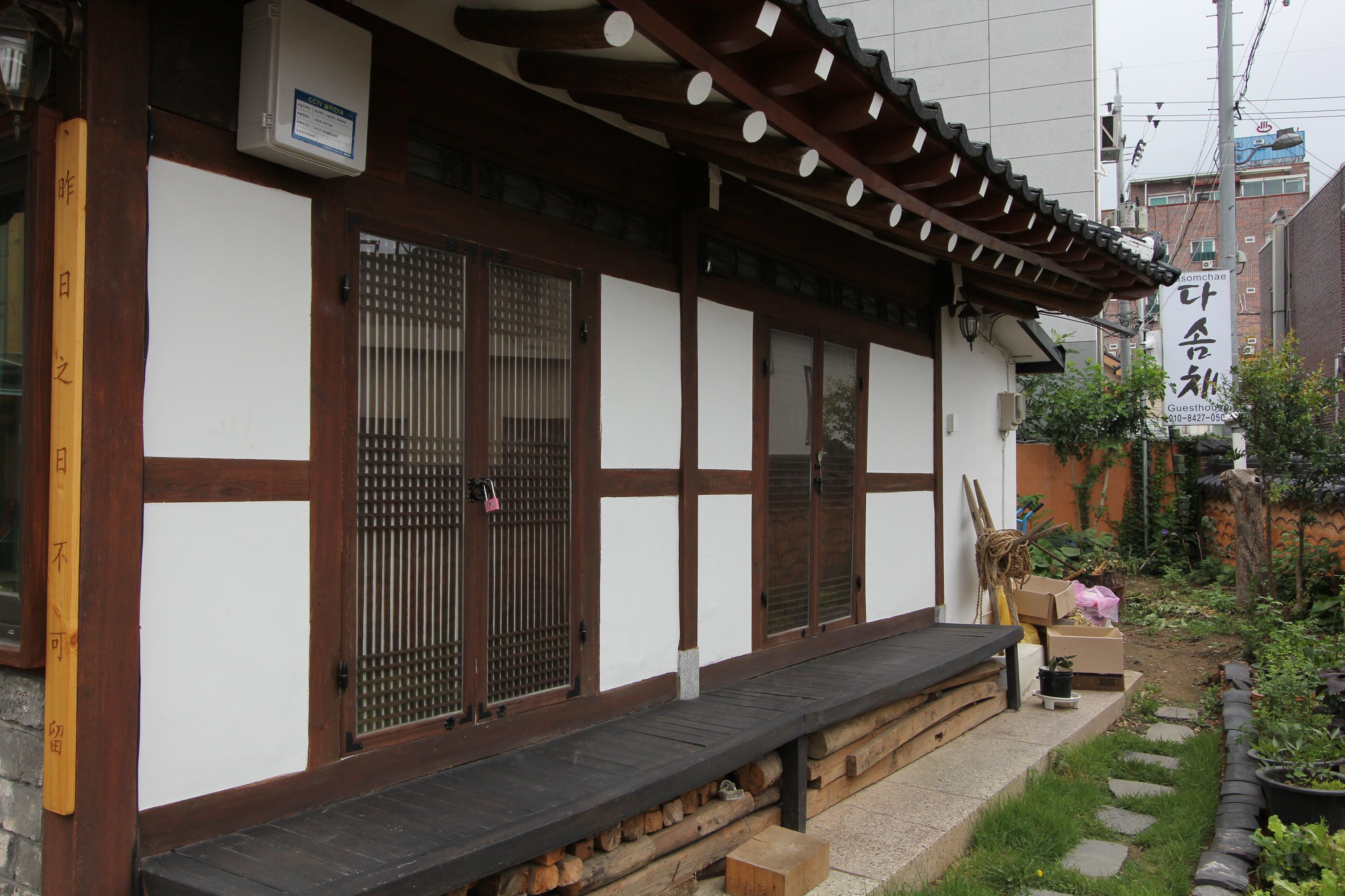 A traditional Japanese building with a wooden exterior, large sliding doors, and a small porch area.
