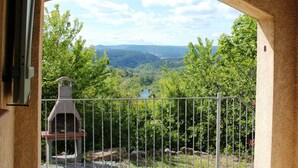 A balcony with a view of a valley and a bird feeder. - Quiet holiday home in Les Vans with pool (Les Vans)
