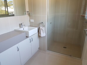 Shower, hair dryer, towels, toilet paper