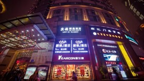 A building with multiple storefronts, including a visible 'Vlyuk' sign and a 'Yearcon' sign. - Vyluk J Hotel Chongqing Jiefangbei (Chongqing)