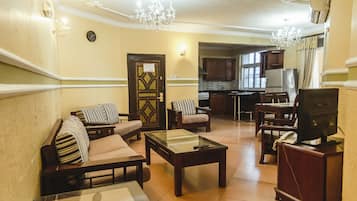 Penthouse, Multiple Beds | Living area | 32-inch flat-screen TV with cable channels, TV