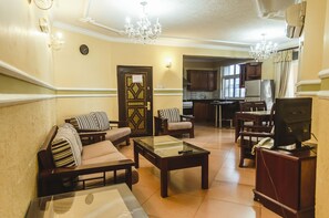 Penthouse, Multiple Beds | Living area | 32-inch flat-screen TV with cable channels, TV - Abla Apartment (Dar es Salaam)