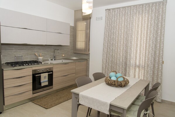 A modern kitchen with a dining area.