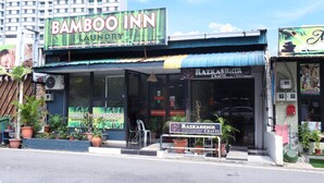 A storefront with a sign for 'Bamboo Inn Laundry' and 'Razzkashmir Crafts'. - Hotel O Bamboo Inn (George Town)