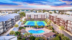 A residential building with a tennis court, pool, and lounge area. - Experience Tilghman Beach and Racquet Club Unit 207! Oceanfront, Pools, Tennis, Close to Main Street! (North Myrtle Beach)