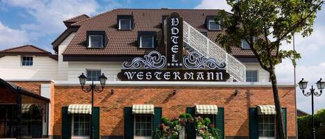 A hotel with a prominent sign reading 'Hotel Westermann' and a classic architectural design.