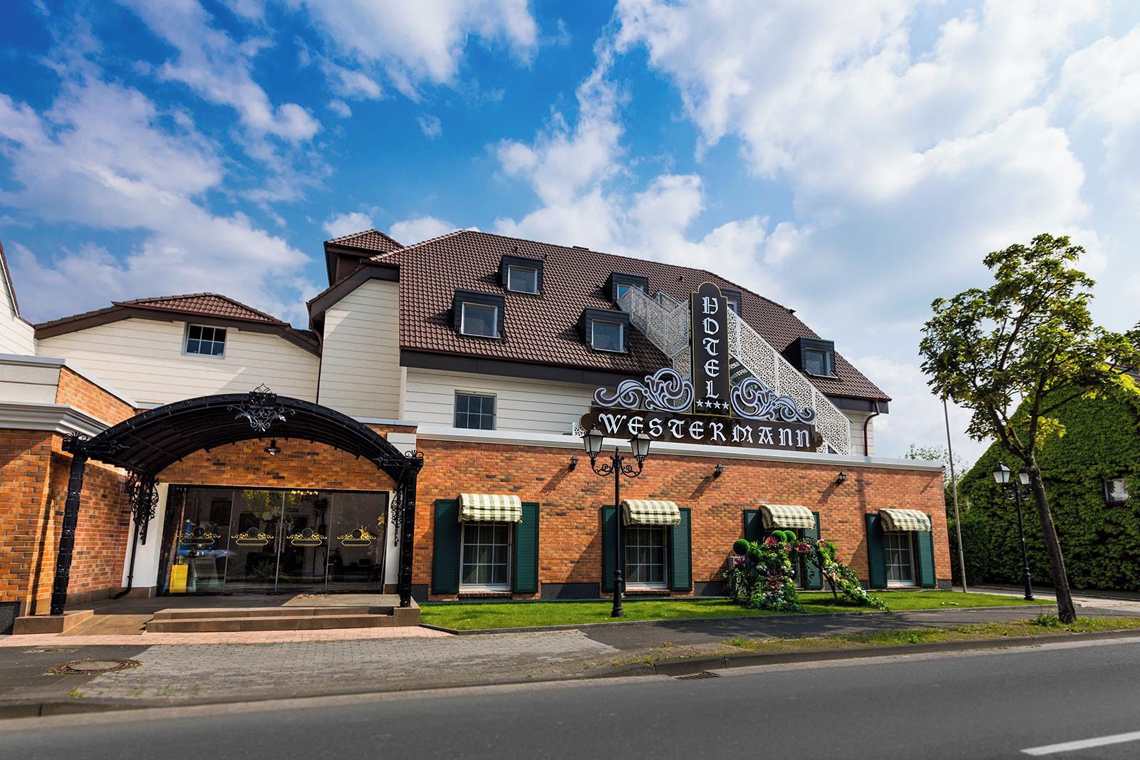 A hotel with a Western-themed facade, including a prominent sign and a brick exterior.