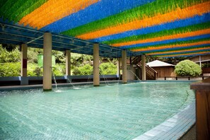 Una piscina interior amb terra de rajola i sostre de colors.