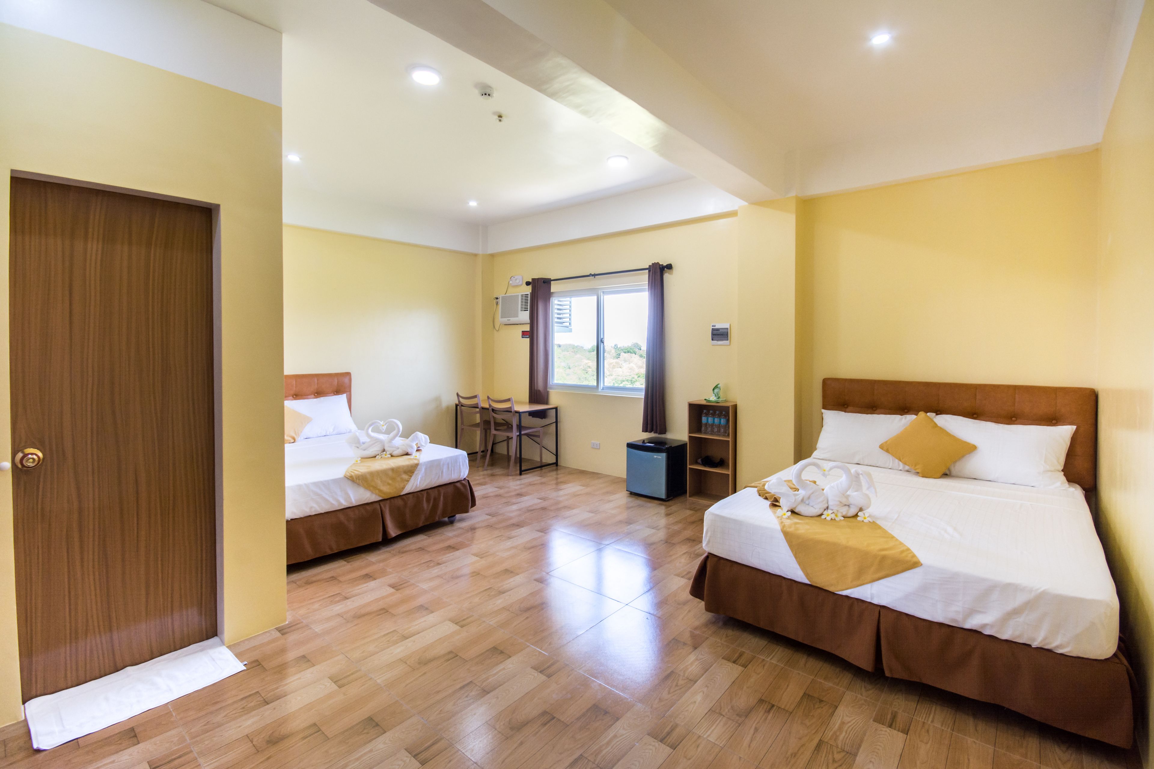 family room, 2 queen beds | 1 bedroom, individually furnished, desk, free wifi