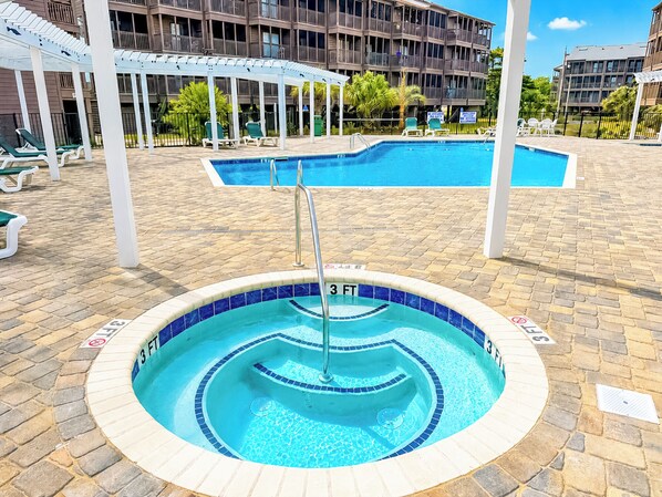 A swimming pool with a 3 FT depth marker, surrounded by a brick deck and white lounge chairs.