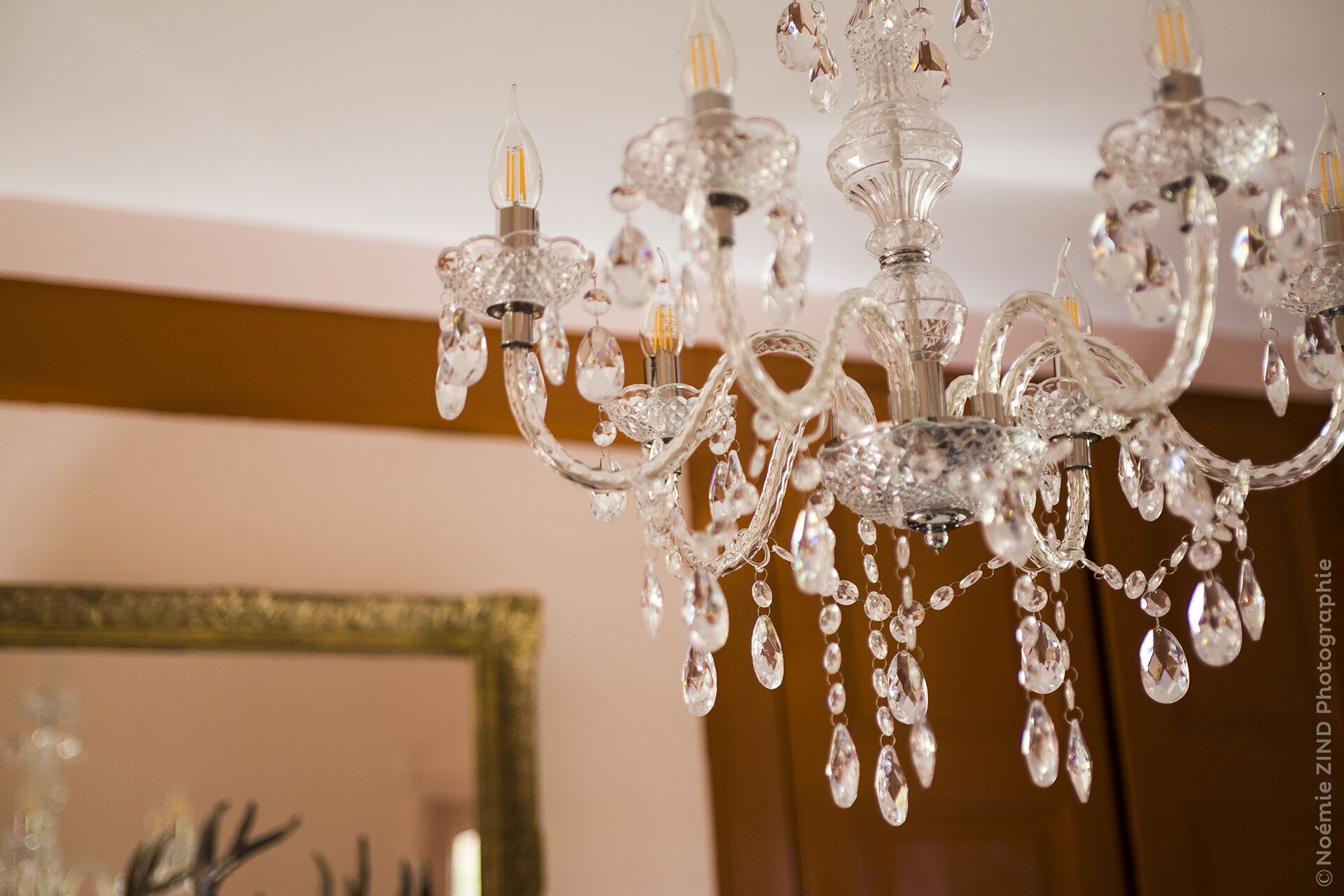 A chandelier with multiple crystal elements and light bulbs.