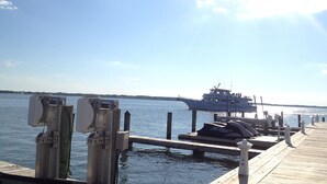 A dock with a boat named 'JUDITH M.' and a jet ski on the pier.