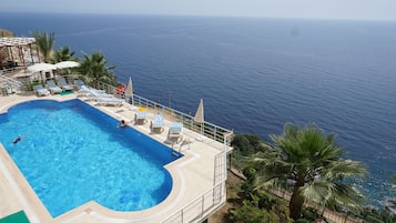 Seasonal outdoor pool, open 8:00 AM to 10:00 PM, pool umbrellas