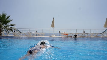 Seasonal outdoor pool, open 8:00 AM to 10:00 PM, pool umbrellas