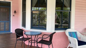 A corner room with a bay window, a small table, two chairs, and a door with a number. - One Short Block to Beach - Spacious Victorian - 1st Floor Bed and Bath (Cape May)