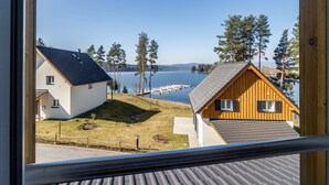 A view of two cabins by a lake with dock access. - Lakeside Village Větrník (Frymburk)