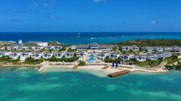 A resort with multiple bungalow-style buildings, a central pool area, and a beach. - Hammock Cove Antigua - All Inclusive - Adults Only (Willikies)