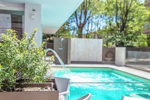 Seasonal outdoor pool, open 10:00 AM to 7:00 PM, pool loungers