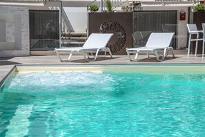 Seasonal outdoor pool, open 10:00 AM to 7:00 PM, pool loungers