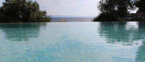 Seasonal outdoor pool, open 8:30 AM to 9:30 AM, pool umbrellas