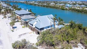A coastal property with multiple buildings, a sandy beach, and a view of the ocean. - Waterfront, Gulf View, Pool is now open tennis, pickleball, kayaks, SUP, dock (Placida)