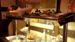A breakfast bar with various food items and a jug of orange juice. - Hôtel Sainte Odile (Obernai)