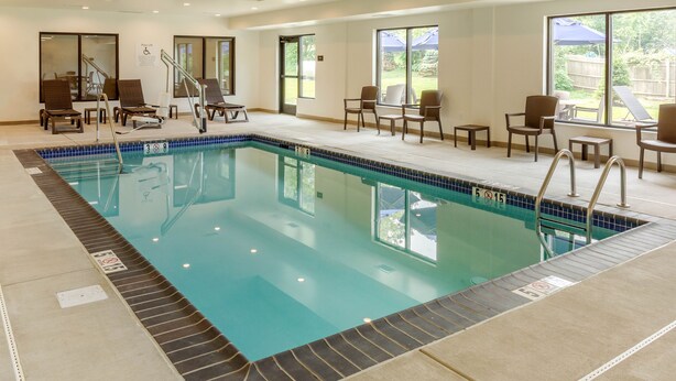 An indoor swimming pool with lounge chairs and a view of the outdoors. - Comfort Inn & Suites Gap Amish Country (Gap)
