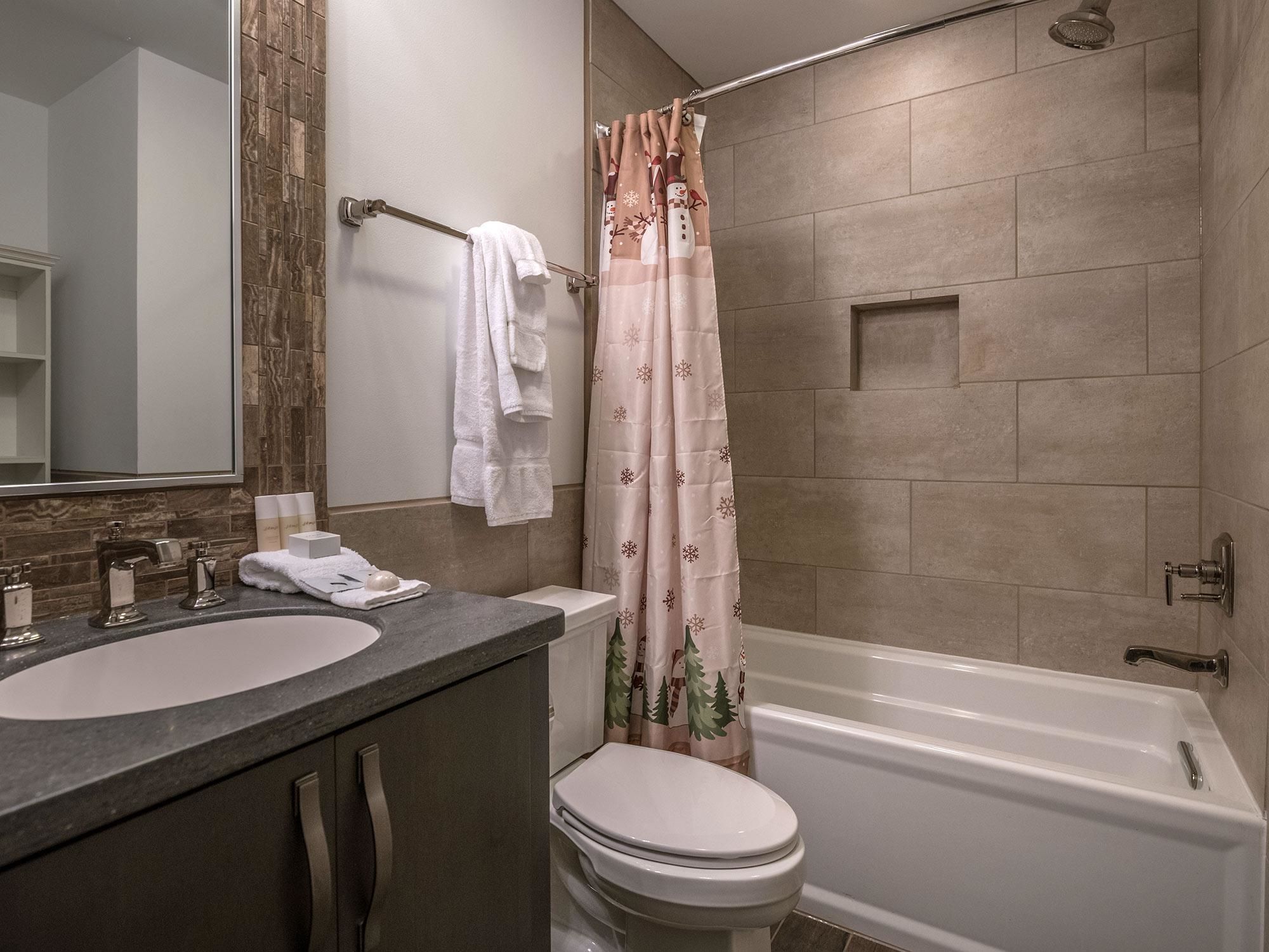 A bathroom with a bathtub, toilet, and sink.