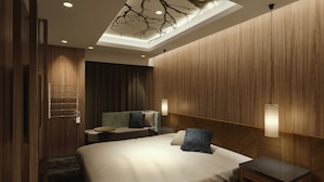A modern hotel room with a wooden ceiling, a bed with a headboard, a small table, and a wall-mounted towel rack. - ALFIT HOTEL & BAR AKASAKA (Tokyo)