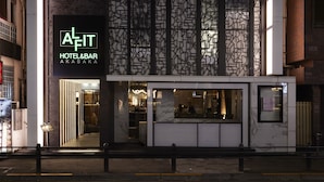 A modern hotel facade with a geometric patterned wall and a prominent sign for 'ALFIT HOTEL & BAR AKASAKA'. - ALFIT HOTEL & BAR AKASAKA (Tokyo)