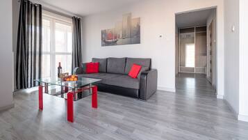 Deluxe Apartment, Multiple Beds, City View | Living room | TV