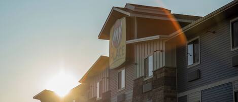 A multi-story building with a sign that reads "MY PLACE HOTEL".