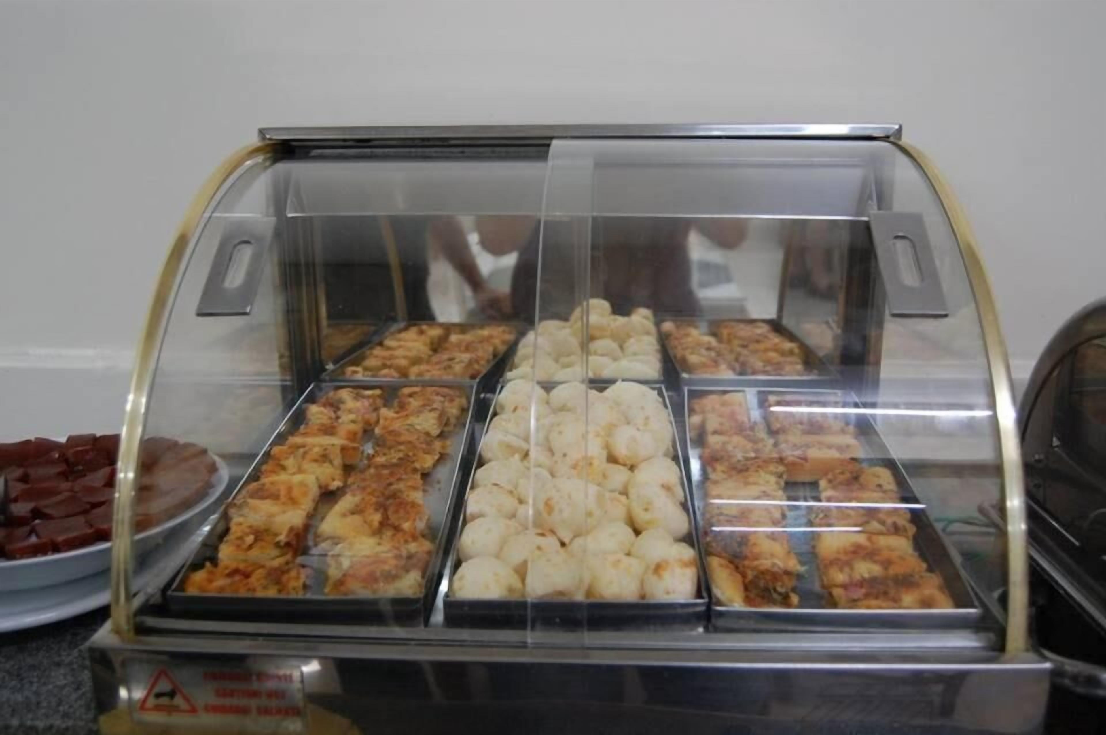 A display case with various baked goods, including pies and pastries, in a bakery or cafe setting.