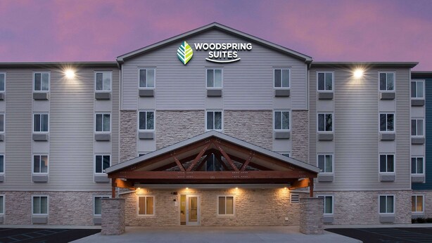 A multi-story hotel with a stone facade and a prominent entrance.