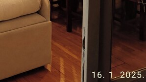 A dining area with wooden chairs and a table, a sofa, and a vase with flowers. - Beautiful apartment in center Sarajevo (Sarajevo)