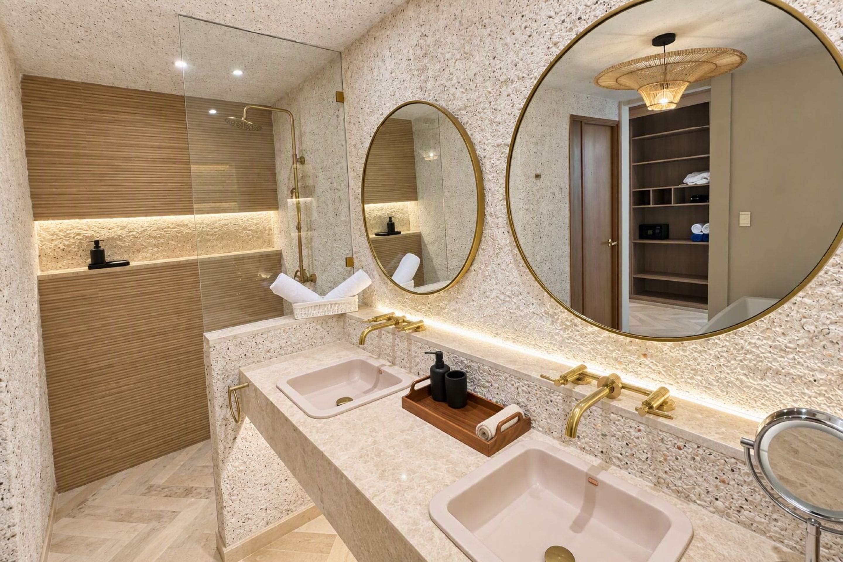 A modern bathroom with two sinks, a large mirror, and a wooden vanity.