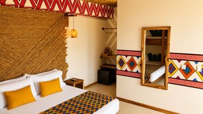 A hotel room with a bed, a bedside table, a mirror, and a wardrobe. - Hotel Wayira Beach by On vacation (Manaure)