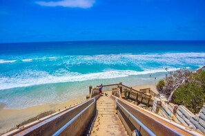 A staircase leading to a beach with ocean views. - Private Pool * Ocean Views * Beach Across The Street! (Encinitas)