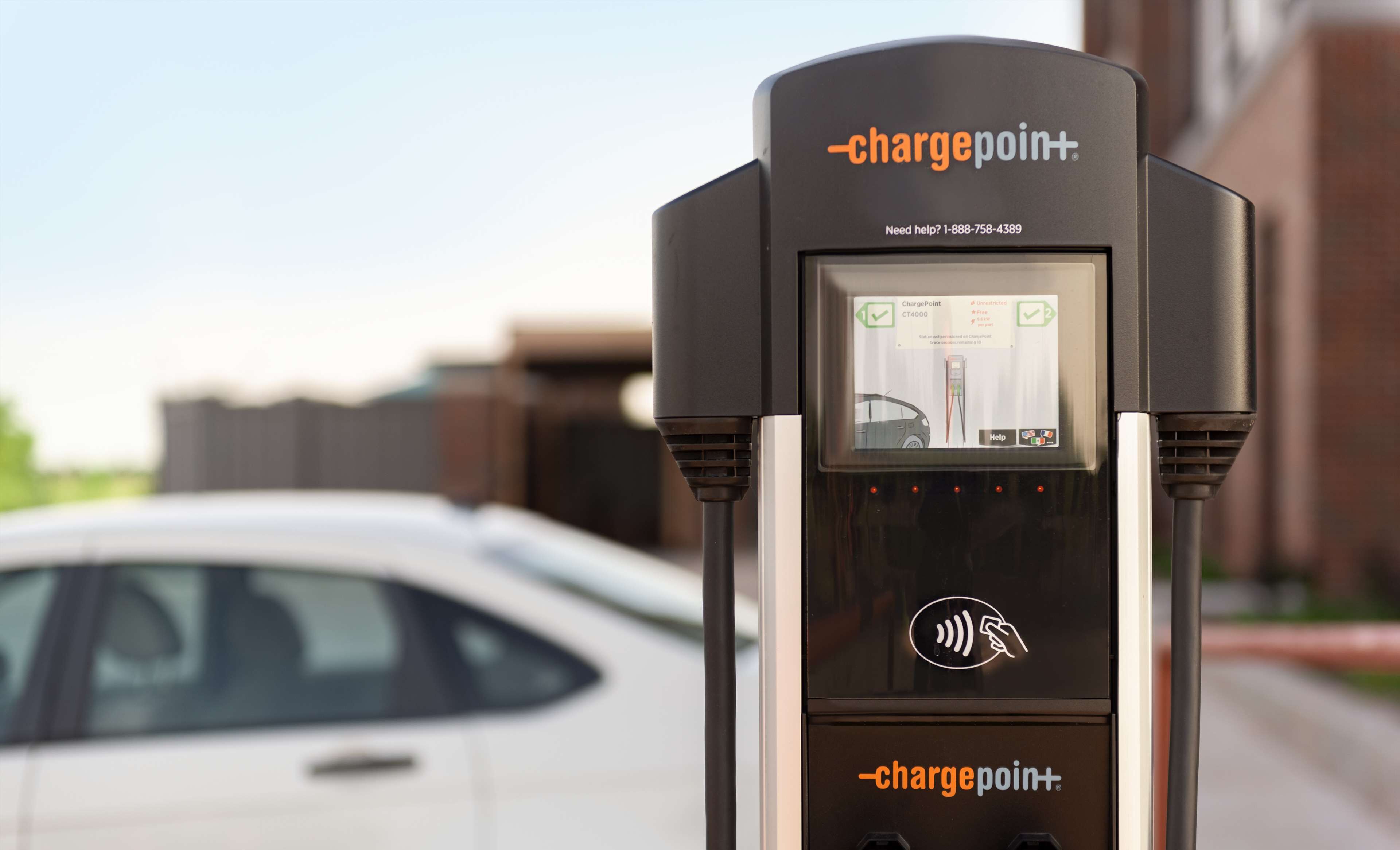 A ChargePoint electric vehicle charging station with a digital display, a payment interface, and a charging cable.