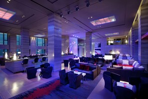 A modern hotel lobby with a bar area, seating arrangements, and large windows. - Hilton Xi'an High-tech Zone (Xi'an)