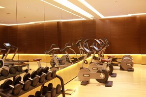 A gym with multiple exercise machines and a rack of dumbbells. - Hilton Xi'an High-tech Zone (Xi'an)